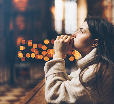 Photo of woman praying in church