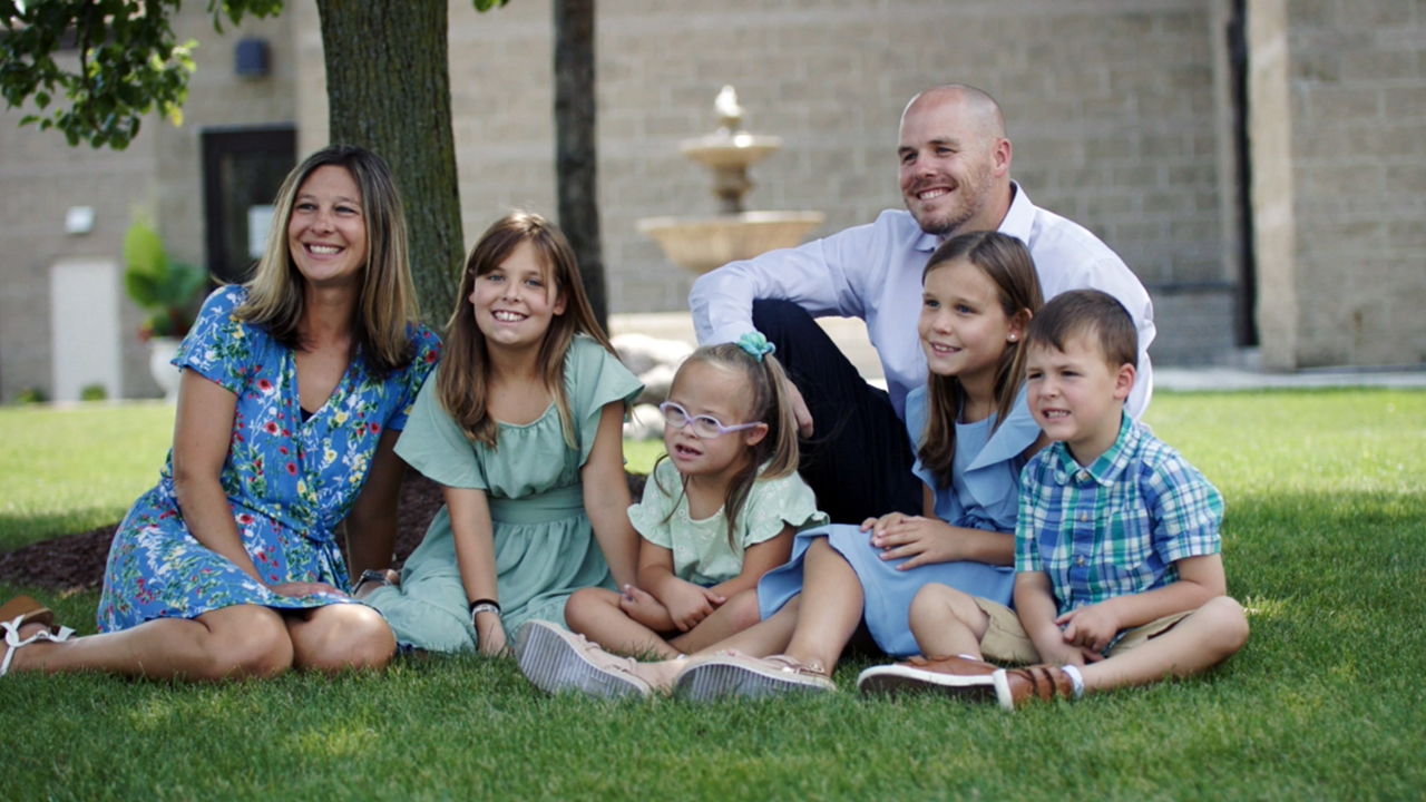 Portrait of a family of six sitting on the grass