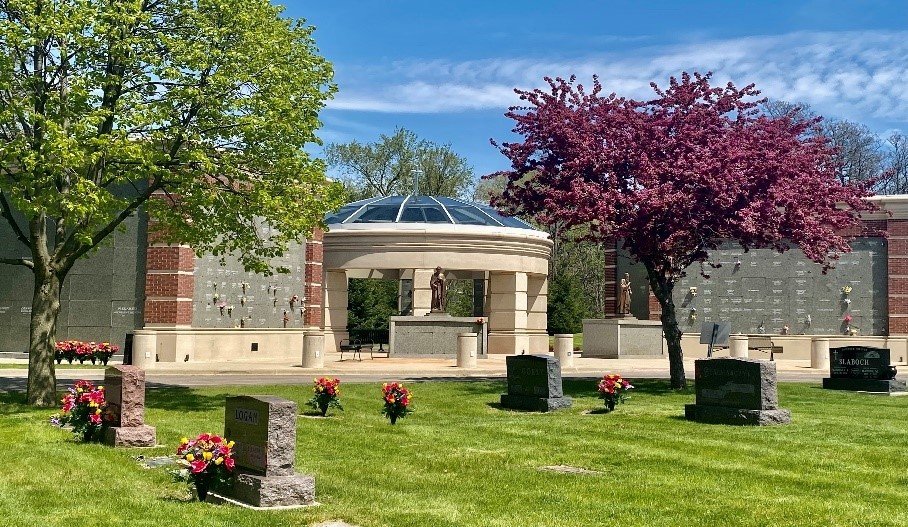 image of a cemetery with blue skies and green grass